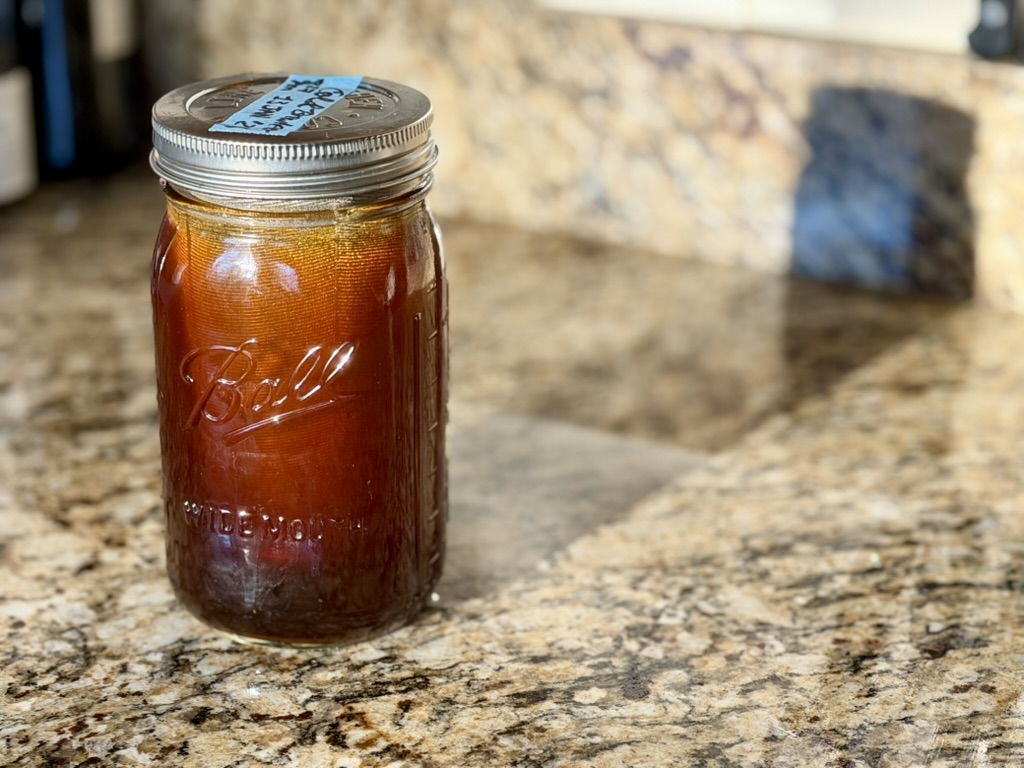 A Ball jar of cold brew sits on a granite counter, awaiting the 24-hours of steeping to come.