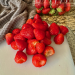 Strawberries, hulled, on a cutting board. Waffle weave kitchen towel in background. Japanese butcher knife in foreground. Photo by Diana Ludwick (c) 2026.